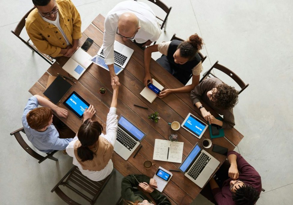 Top down people around table working together